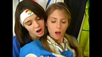 Girls from argentina and italy football uniforms have a nice time at the locker room